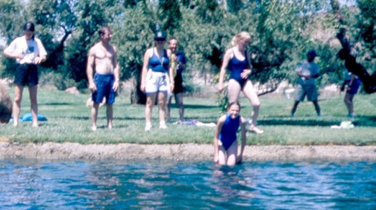 Mariette Lindstein (far right on grass with left knee bent) at a staff recreation day at the lake at Golden Era Productions 1997.